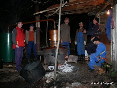 Kuhanje žganja in domača pesem.